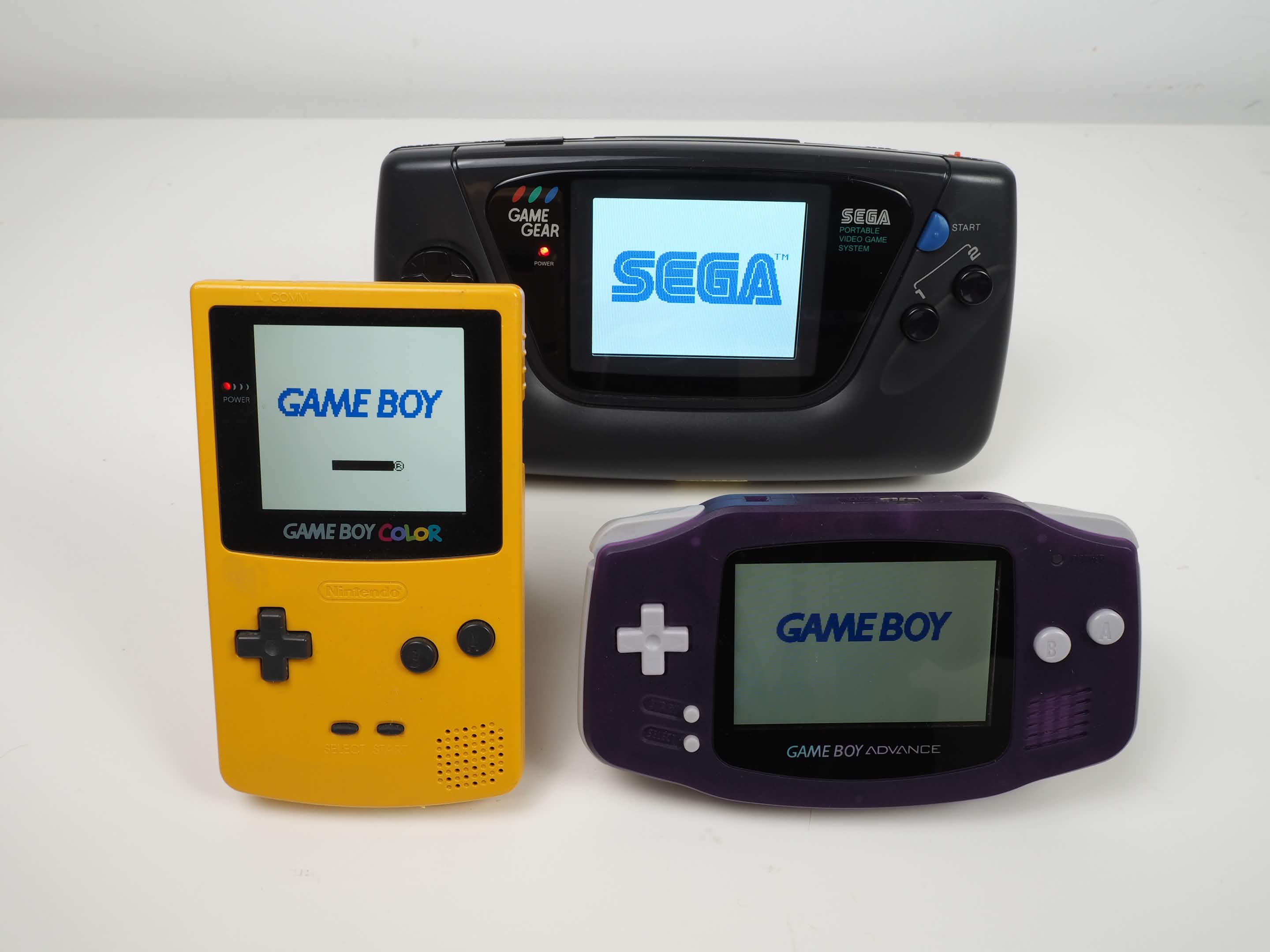 picture of handheld consoles with modded newer screens